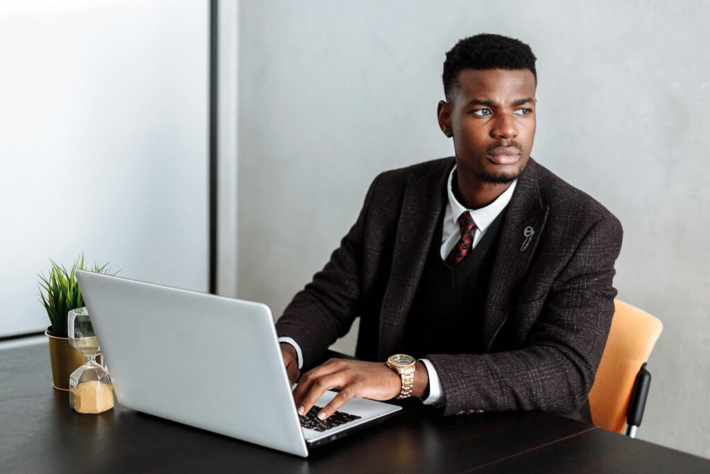 Man in Black Suit Jacket Using Laptop Computer