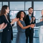 Employees shaking hands and celebrating