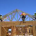 New construction framing being assembled by a crew