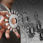 Businessman hand shows cogs