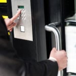 Man entering security code to unlock the door