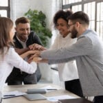 Top Employee Engagement Survey Companies for Enterprise HR Teams in 2026 6 Successful diverse employees stacking hands