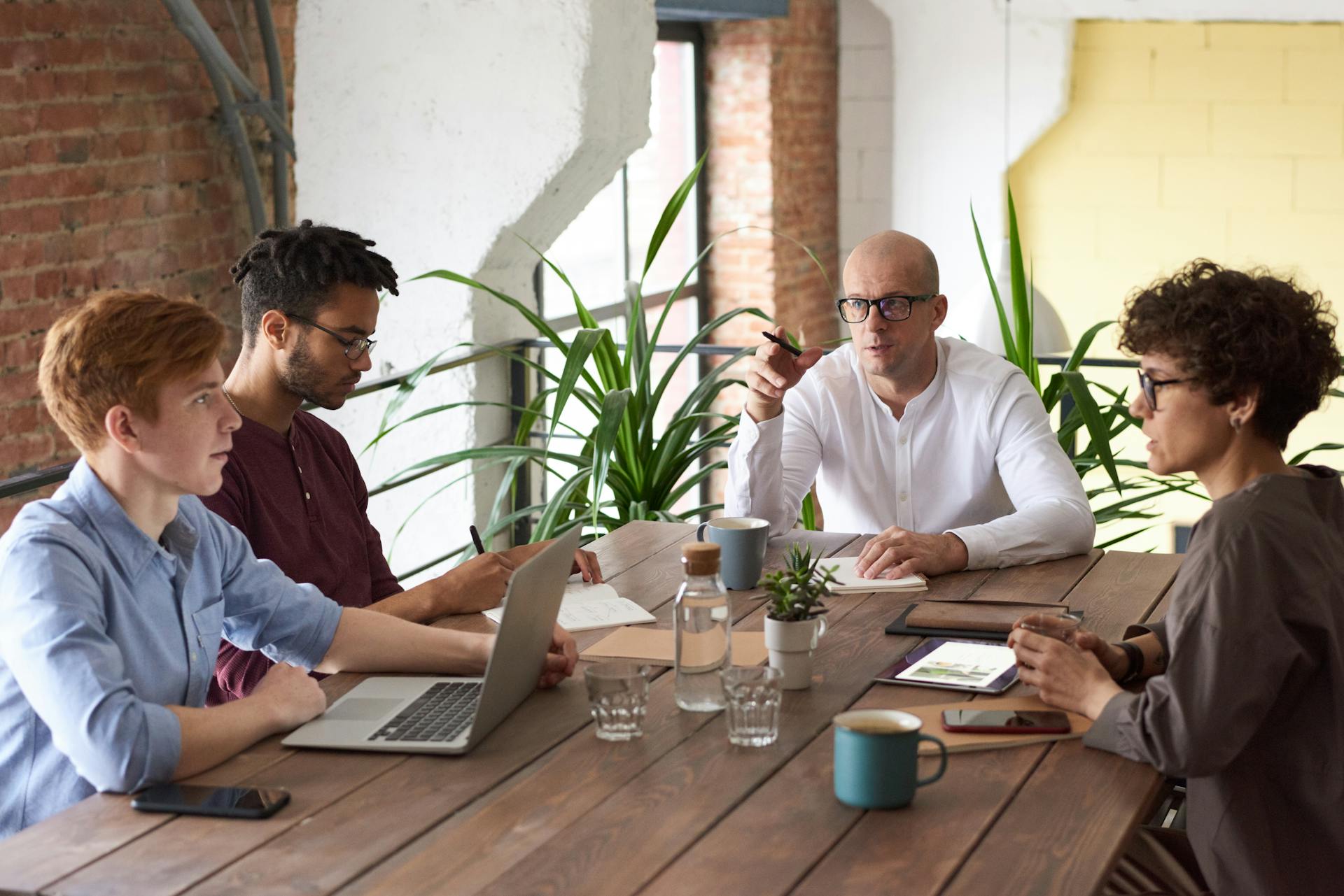 Employees talking around a table