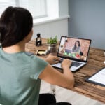 Young Woman Videoconferencing With Colleague