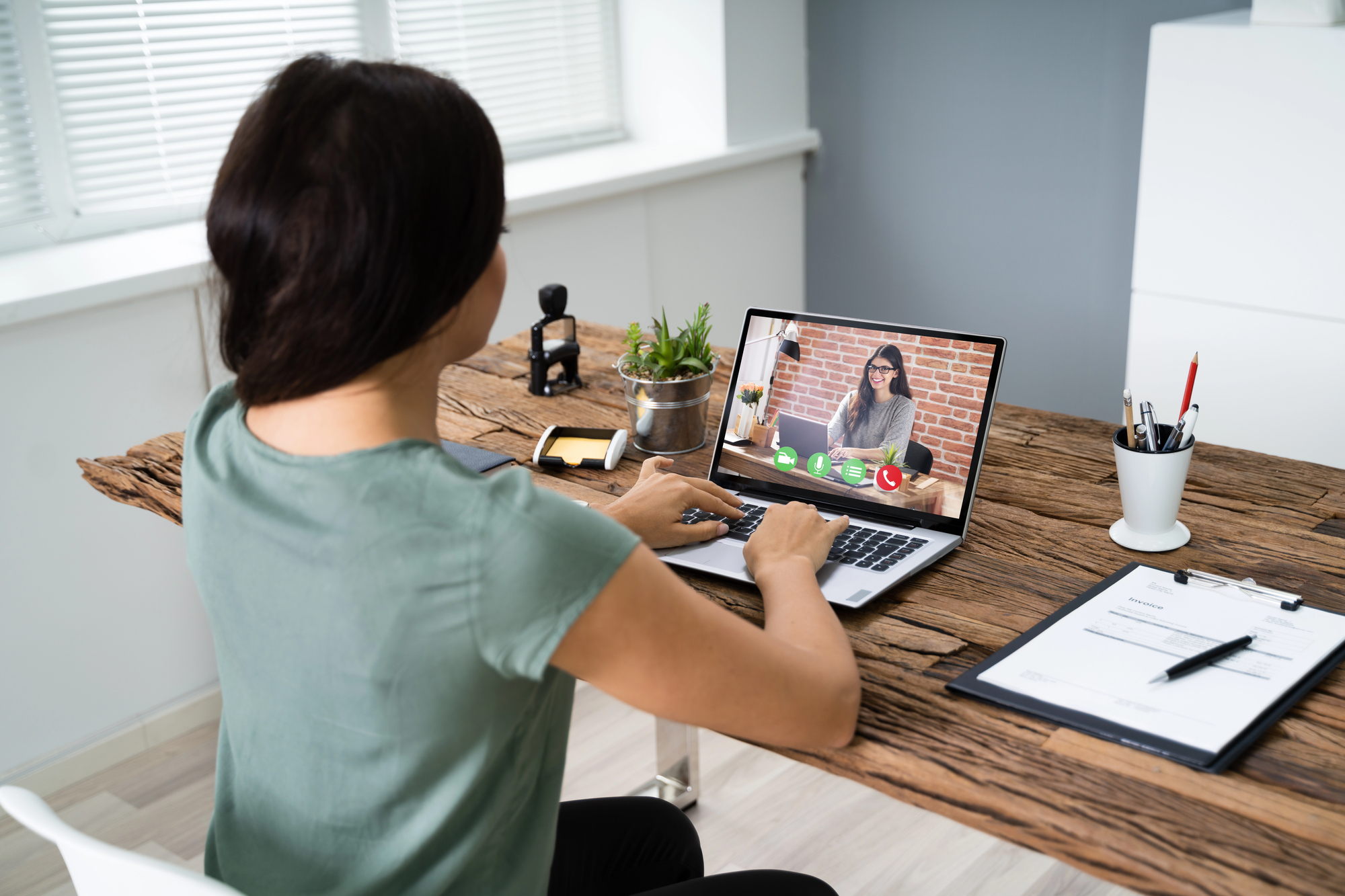Young Woman Videoconferencing With Colleague