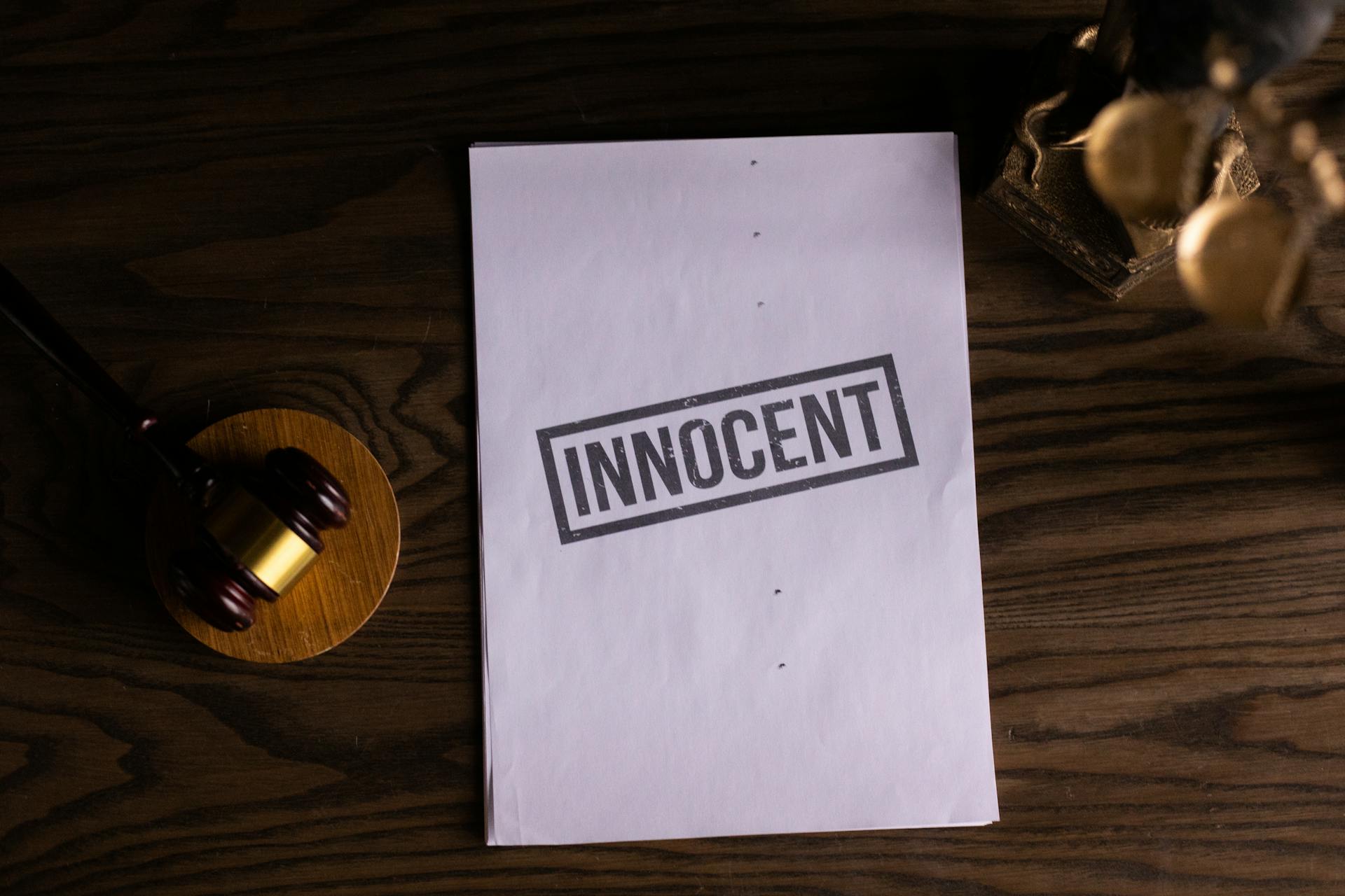 Close-Up View of a Text on a Paper beside a Gavel