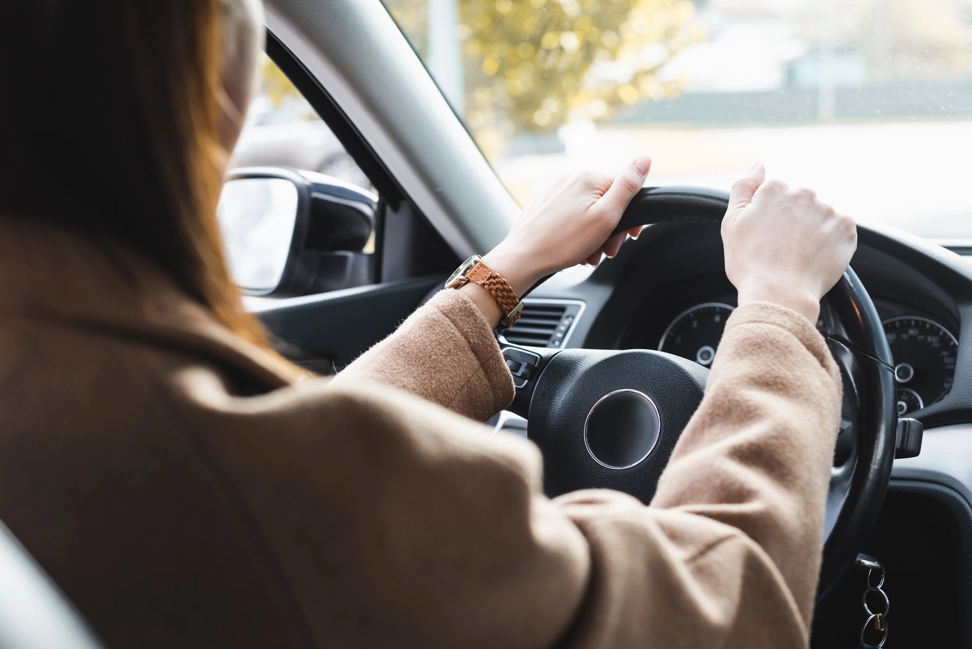 Cropped of woman driving car on blurred foreground