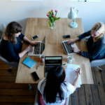 Female co-workers working around a table