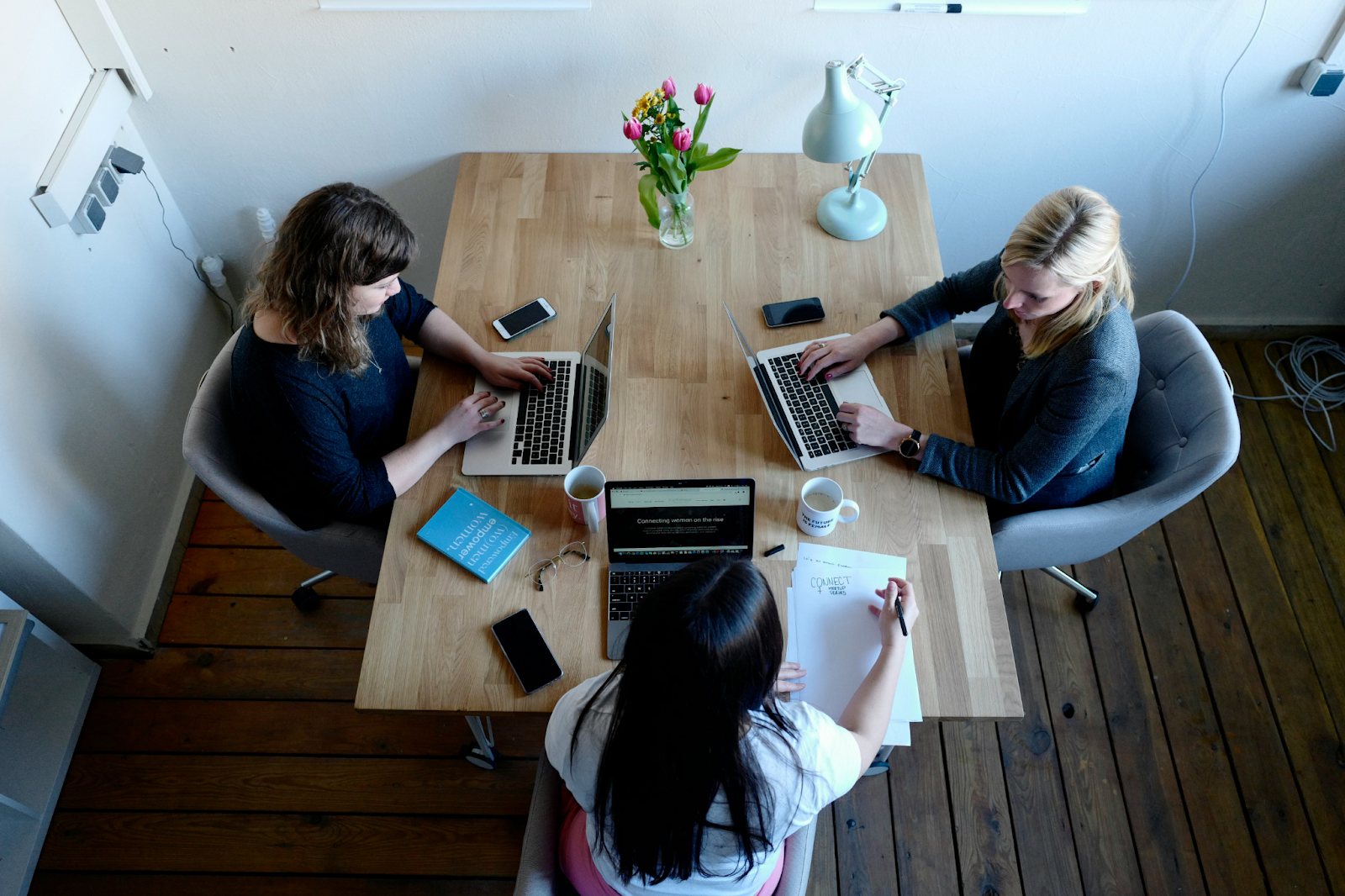 Female co-workers working around a table