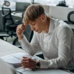 Man sitting at a desk looking at documents