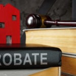 Probate law book and a model of house on it