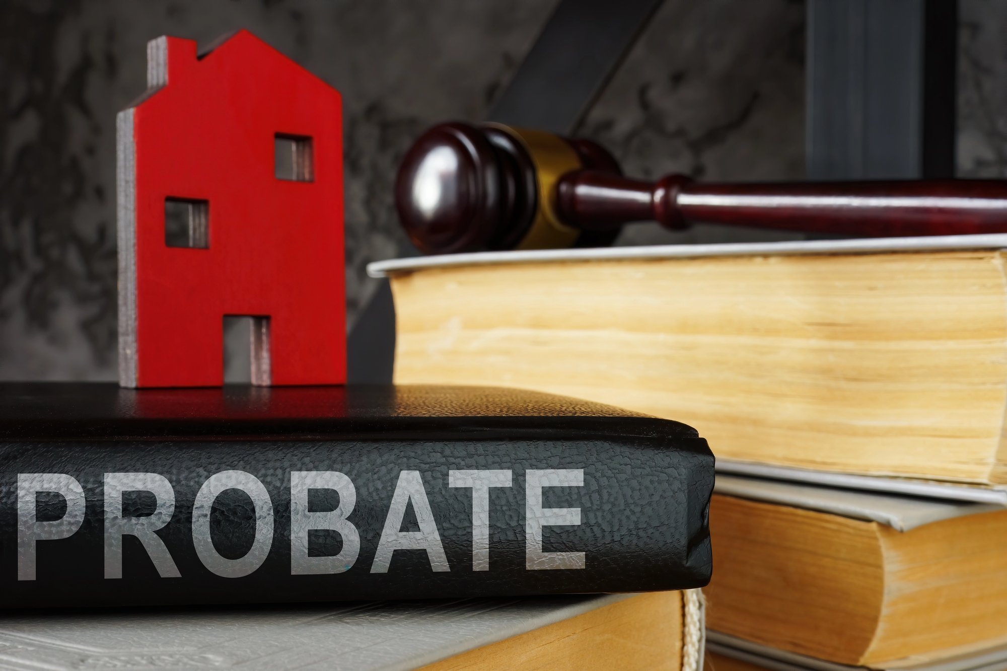 Probate law book and a model of house on it