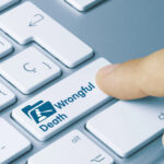 Wrongful Death Written on Blue Key of Metallic Keyboard