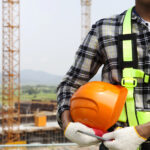 Close up construction worker holding helmet