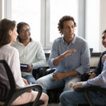 An Employerโs Guide to Providing Addiction Recovery Support to Employees 9 Motivated inspired business team employee man talking to colleague