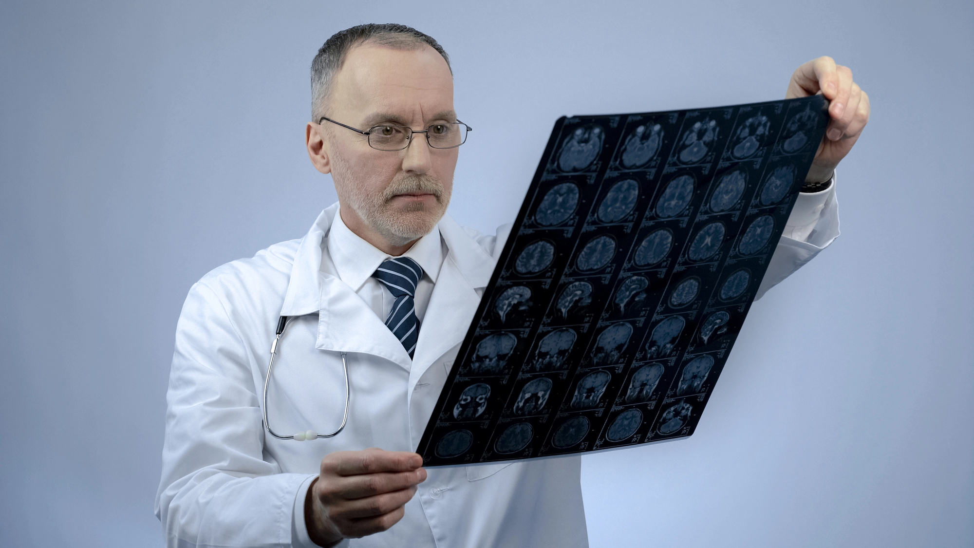 Professional neurosurgeon checking MRI brain image