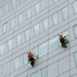 a few men climbing a building