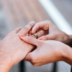 When Career Shifts Impact Marriage: Postnuptial Agreements as a Safety Net 6 a man and a woman holding hands with a wedding ring