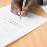 Finding a Notary: Key Considerations and Best Practices 9 person writing on white paper
