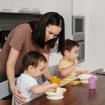 A Woman in Brown Shirt Feeding Her Kids