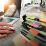 Business documents on office table with smart phone and laptop