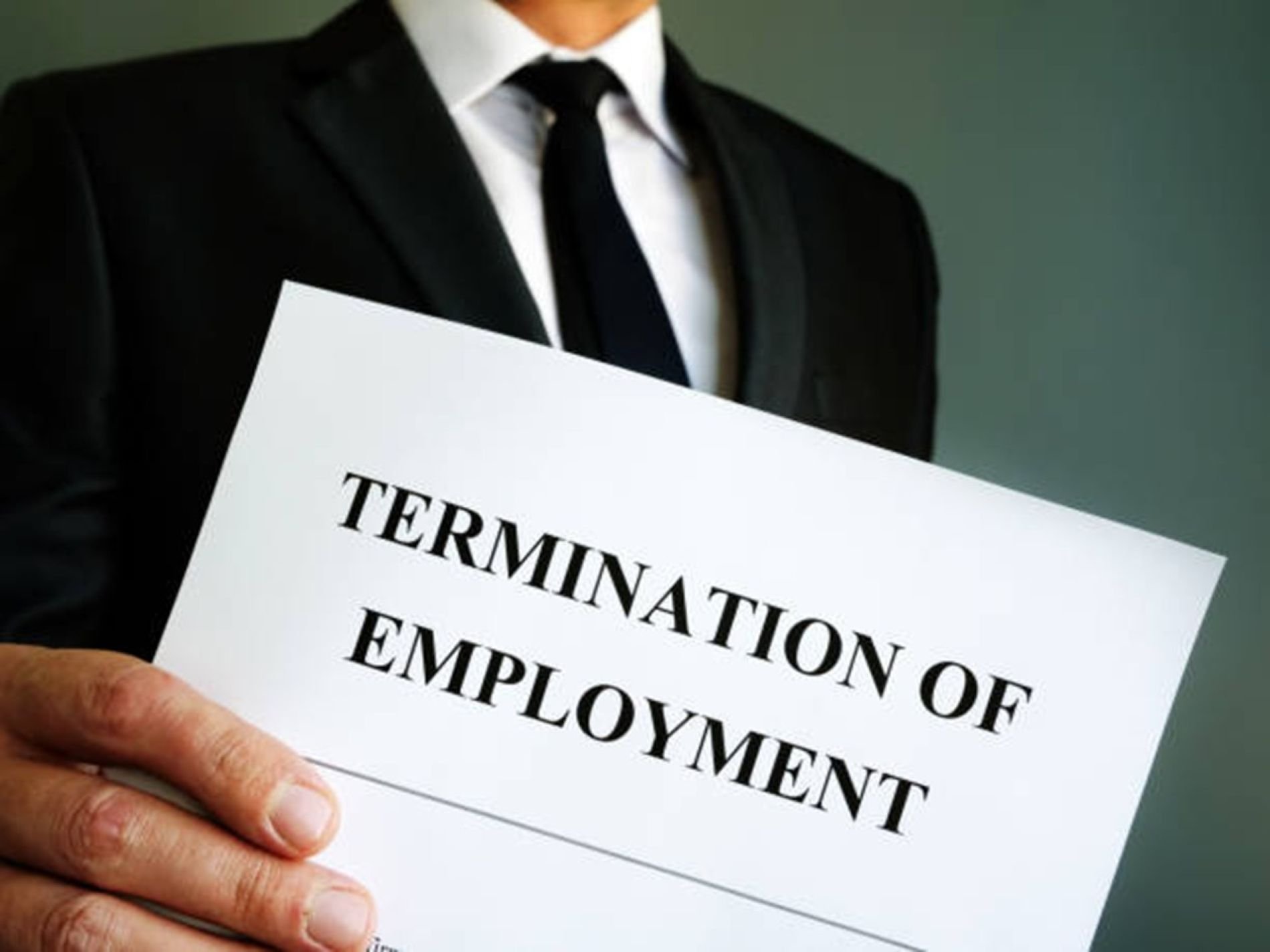 Man holding termination of employment sign