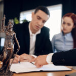Man signing documents at lawyer office
