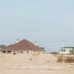 Why Apps for Property Lines Are Replacing Traditional Surveying 9 Surveyors with digital level ruler on working on dirt road