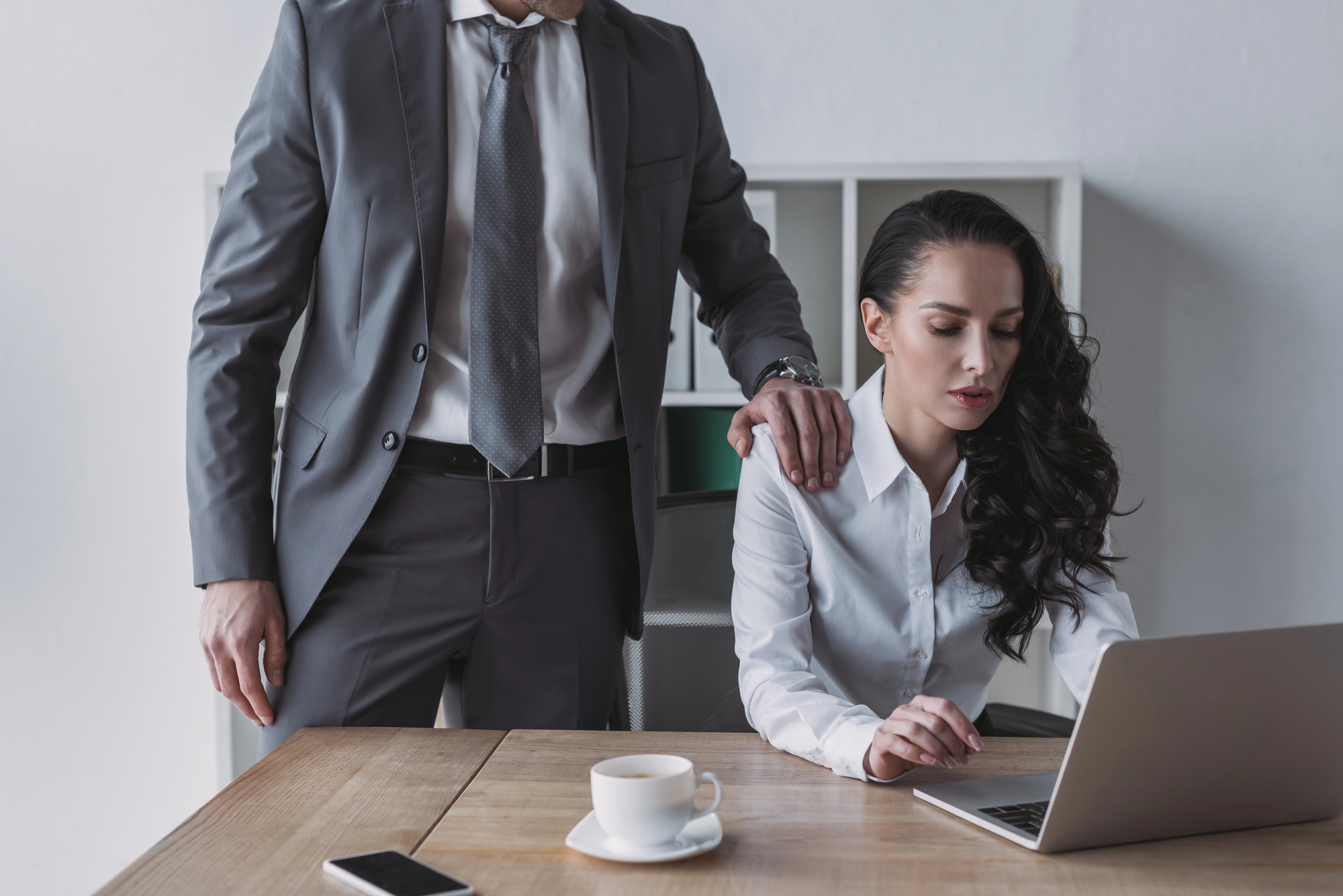 Businessman touching shoulder of secretary
