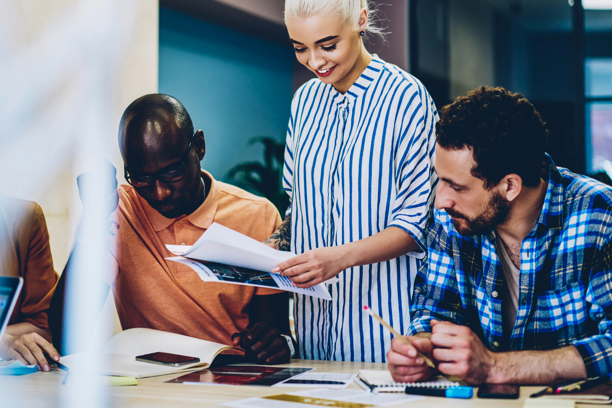 Cheerful female leader of working multiracial group