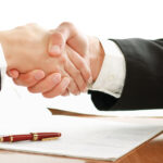 Handshake after signing an employment agreement