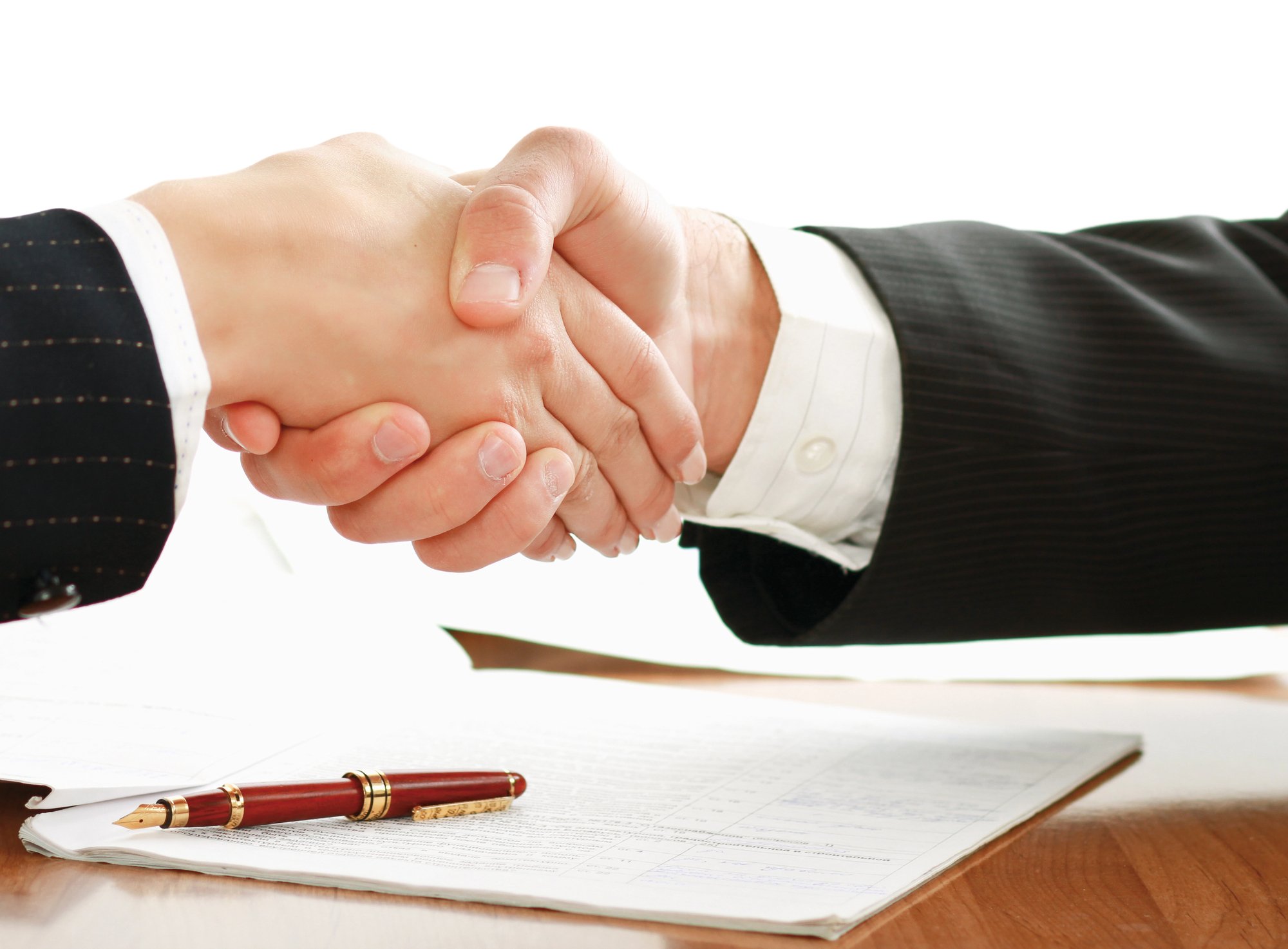 Handshake after signing an employment agreement