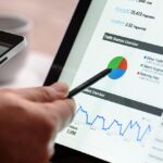 Man looking at a graph on a laptop