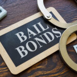 Plate Bail bonds and handcuffs on it