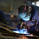 Welders working at the factory made metal