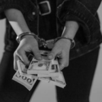 Woman in handcuffs holding cash