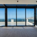 an empty room with a view of the ocean