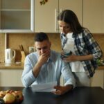 When Financial Struggles Hit: How to Bounce Back 6 Couple looking stressed over bills at kitchen table
