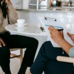 How HR Professionals Help Businesses Adapt to New Employment Regulations 8 Crop faceless multiethnic interviewer and job seeker going through interview