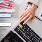 HR professional pressing multilingual key on laptop