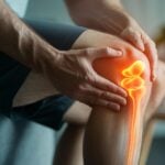 Man holding his injured knee