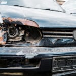Selective focus of damaged headlight in automobile after car accident