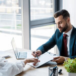 Selective focus of handsome recruiter near attractive employee
