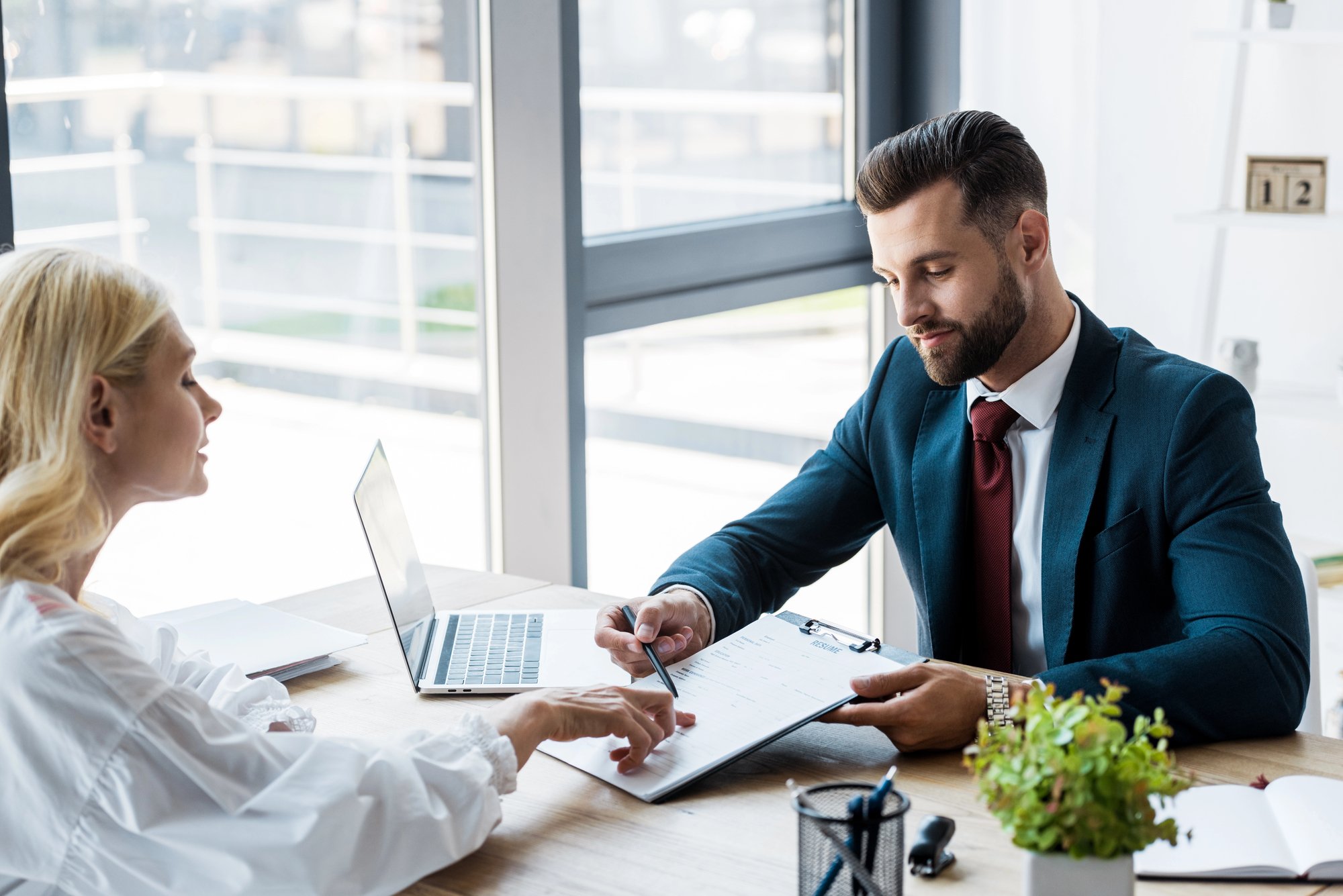 Selective focus of handsome recruiter near attractive employee