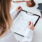 Selective focus of woman holding pen near document with visa