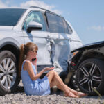 Stressed woman driver talking on mobile phone on street side