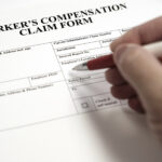 Workers Compensation Complaint Form Hand signing document