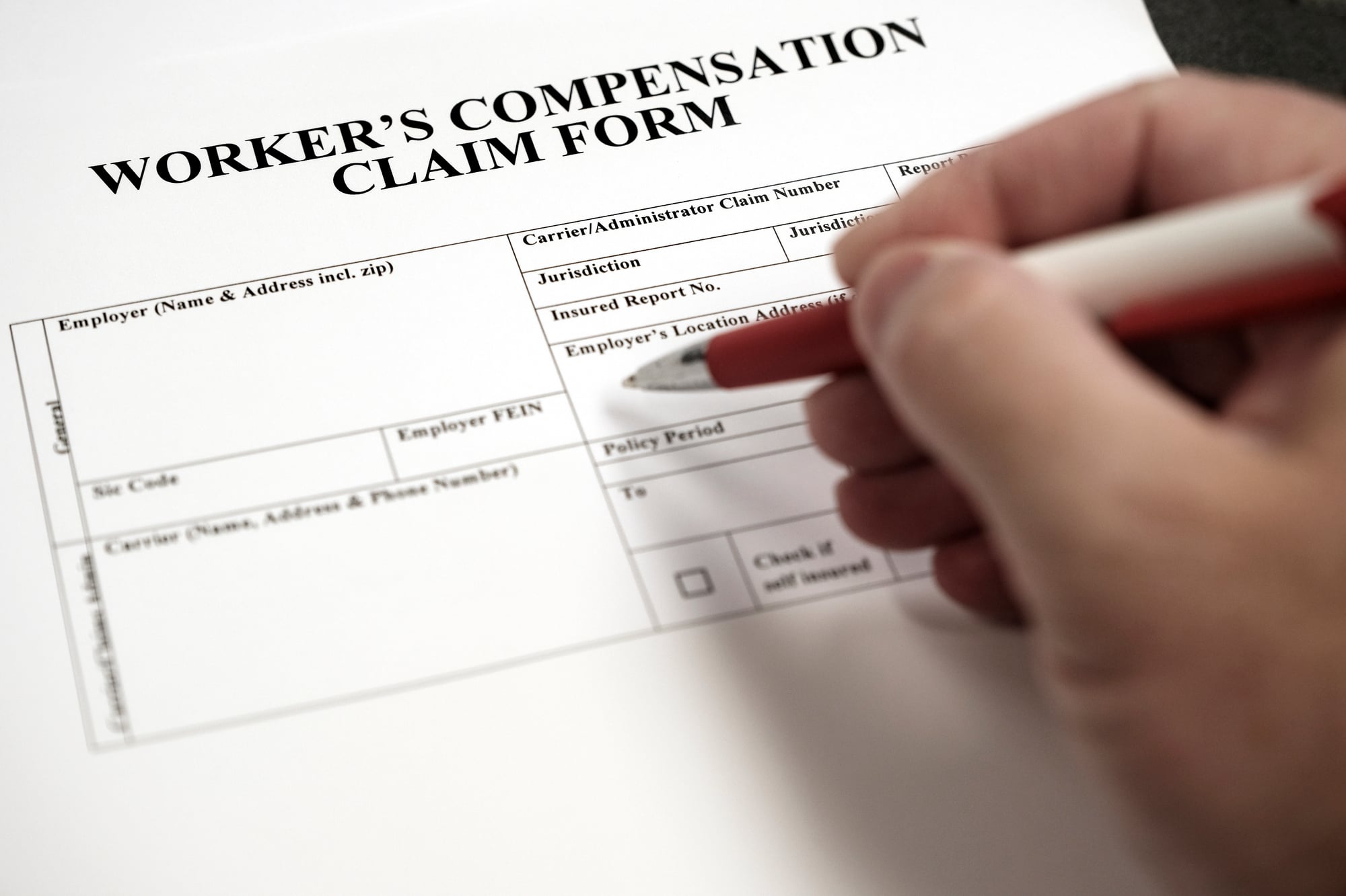 Workers Compensation Complaint Form Hand signing document