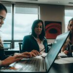 How HR Can Audit SaaS Licenses for Cost and Compliance 8 a group of women sitting around a laptop computer