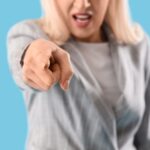 Woman pointing her finger to the camera